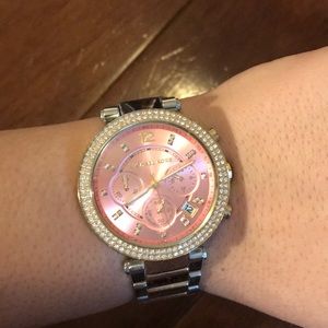 Women’s gold and silver Michael Kors watch.